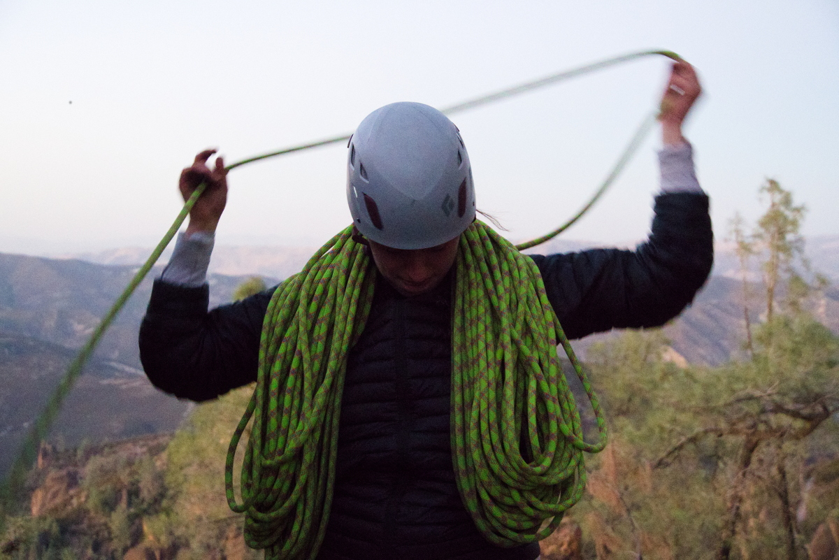 Mack coiling the rope after climbing.